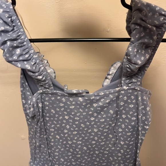 One she is tank top blue with flowers on - Picture 2 of 2